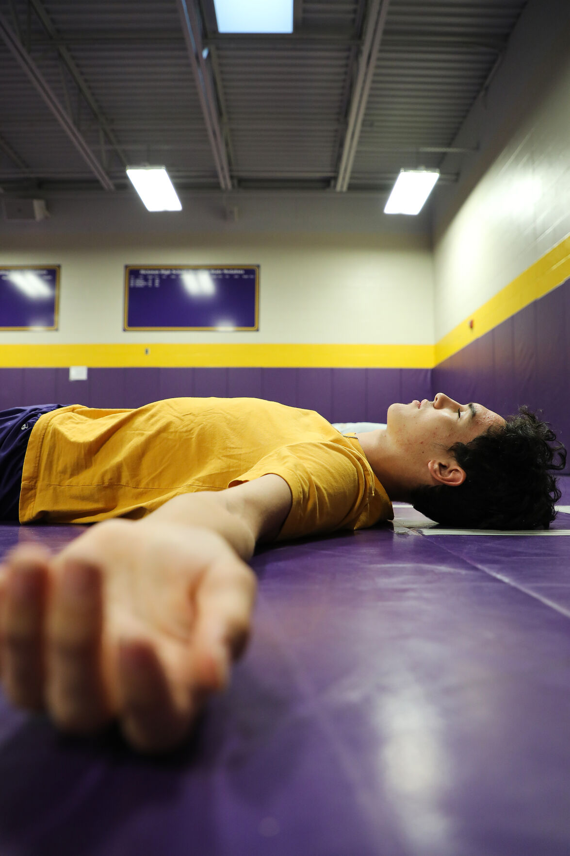 Hickman high school sophomore Lucas Murray rests after an early morning yoga session